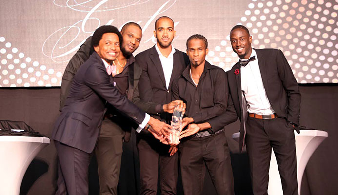 TT Olympic Committee boss Brian Lewis, left, joins World 4x400m champs (from left) Lalonde Gordon, Machel Cedenio, Renny Quow and Jereem Richards after they won the TTOC Sportsman of the Year award on Friday at the Hyatt Regency, Port of Spain.