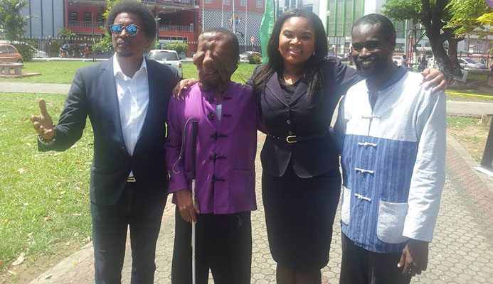 Visually impaired martial arts athlete Shawn Sealy of Barbados, second from left, at the Olympic Day celebrations at Woodford Square, on Friday. Also in the photo are president of the TT Olympic Committee Brian Lewis, left, Minister of Sport and Youth Affairs Shamfa Cudjoe, second from right, and Sealy’s coach Erskine Husbands.