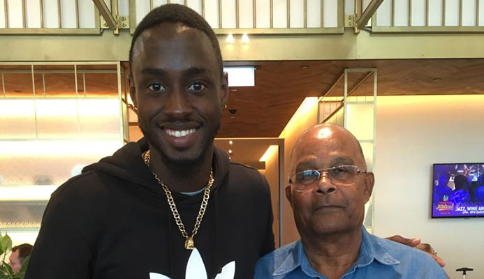 Jereem Richards (left) and Kenneth Ferguson pose with his 200m gold medal at LAX Airport.