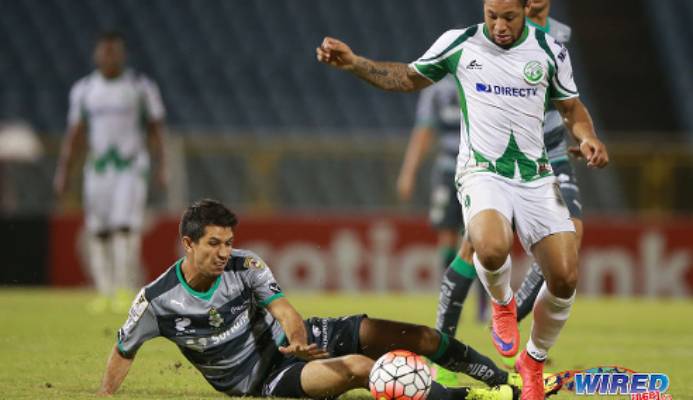 Photo: W Connection attacker Shahdon Winchester (right) evades a tackle from Santos Laguna defender Jesus Molina during 2015/16 CONCACAF Champions League action. (Courtesy Allan V Crane/Wired868)