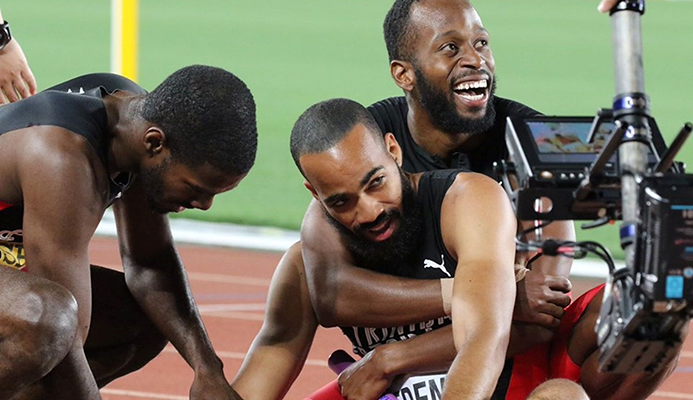 Deon Lendore hugs Machel Cedeno as they celebrate with Asa Guevara, left, after T&T 4x400 metres team copped goal at the IAAF World Relay in Yokohama, Japan, Sunday. The team won the event in a world-leading time of 3:00.81.