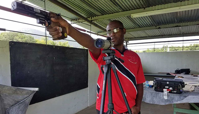 Roger Daniel points his pistol towards the target 