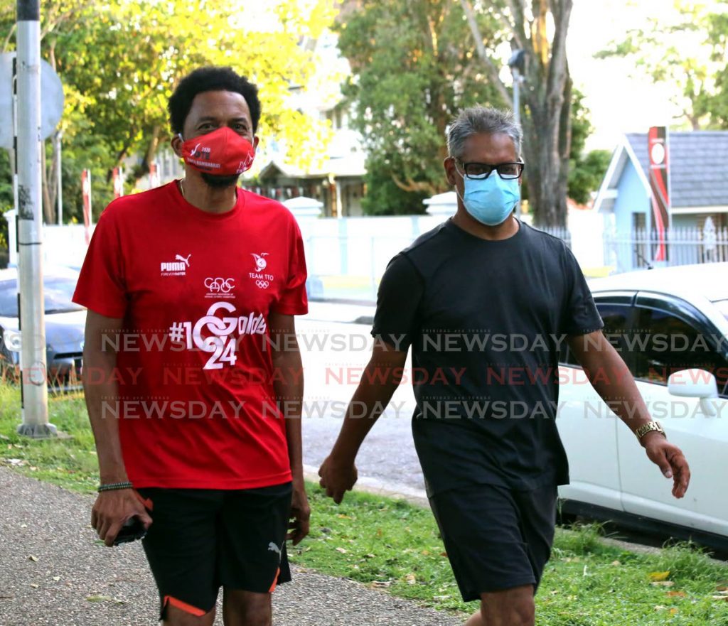 Minister of Agriculture Clarence Rambharat (R) and president of the TT Olympic Committee Brian Lewis exercise around the Queen's Park Savannah, Port of Spain. - Sureash Cholai