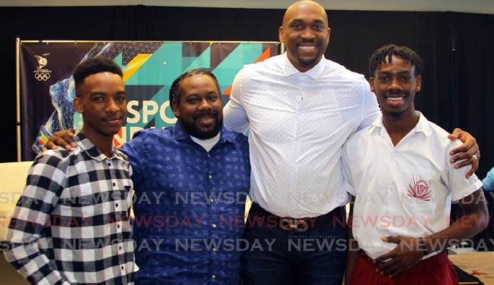 Kibwe Trim, former professional basketballer and founder of DreamChaser International Foundation, second from right, with brothers Zion Nicholas, left, and Israel Nicholas, right, recipients of the Scholar Athlete of the Year Award 2020 from the DreamChaser International Foundation, alongside their father Kieno Nicholas at the annual TT Olympic Committee Sport Industry Conference 2020, held at the Hyatt Regency, Port of Spain, on Thursday. - ROGER JACOB