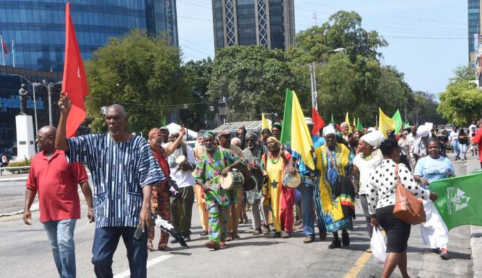 Members of the Black Power Movement march along Independance Square, Port-of-Spain, yesterday, in celebration of the 50th anniversary of the black power revolutionaries who stormed into the Cathedral in 1970 and defaced the statues of saints, since they said it was wrong to portray Jesus as white.