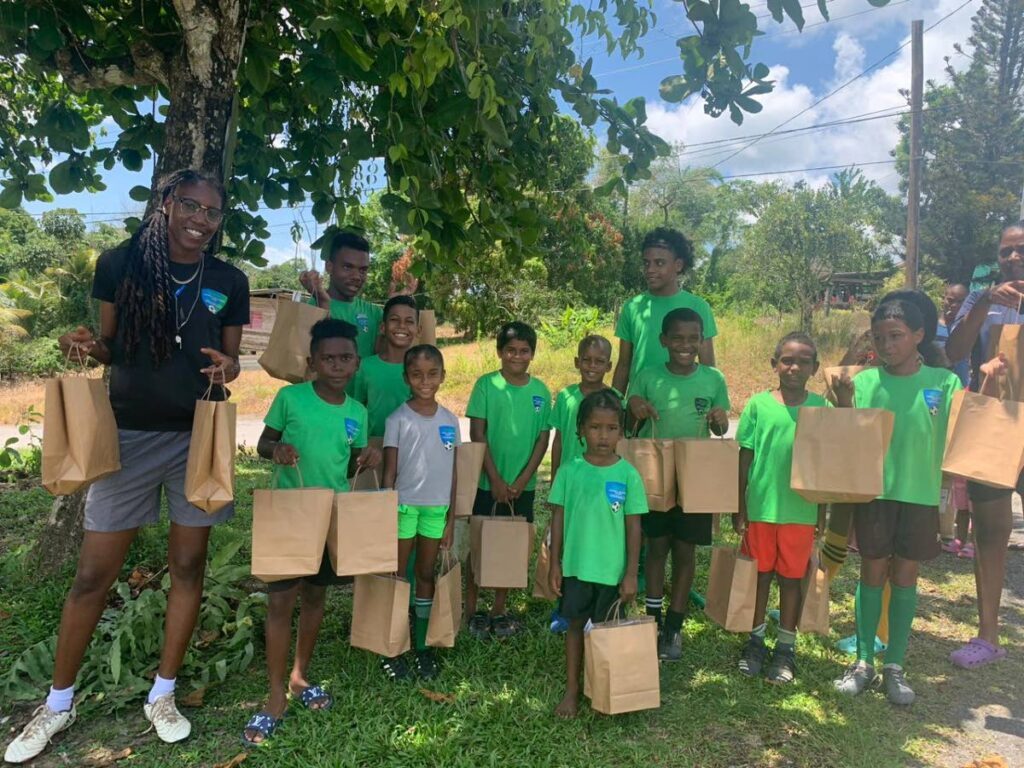 Denice Dedier, left, with some of the youths in the Seed of Greatness programme. - (Image obtained at newsday.co.tt)