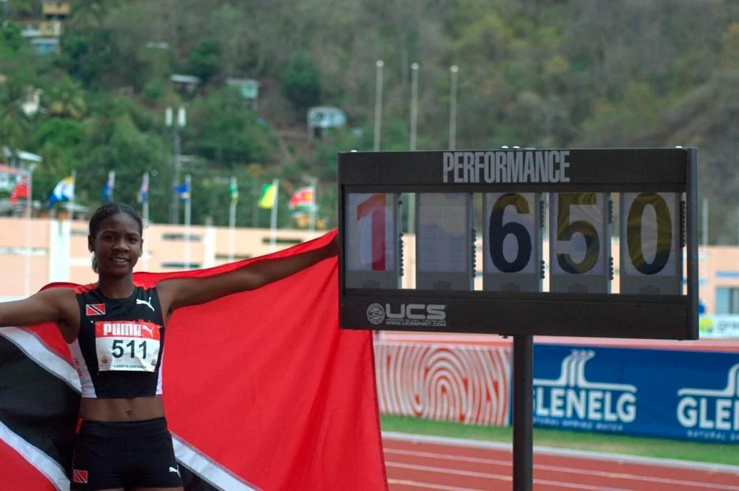 RECORD LEAP: Janae De Gannes celebrates her Carifta Games girls’ Under-20 long jump gold medal and championship record at the Kirani James Stadium, in  Grenada, yesterday. The Trinidad and Tobago athlete won with a 6.50 metres leap--a new personal best and Carifta record. —Photo: PAUL VOISIN (Image obtained at trinidadexpress.com)